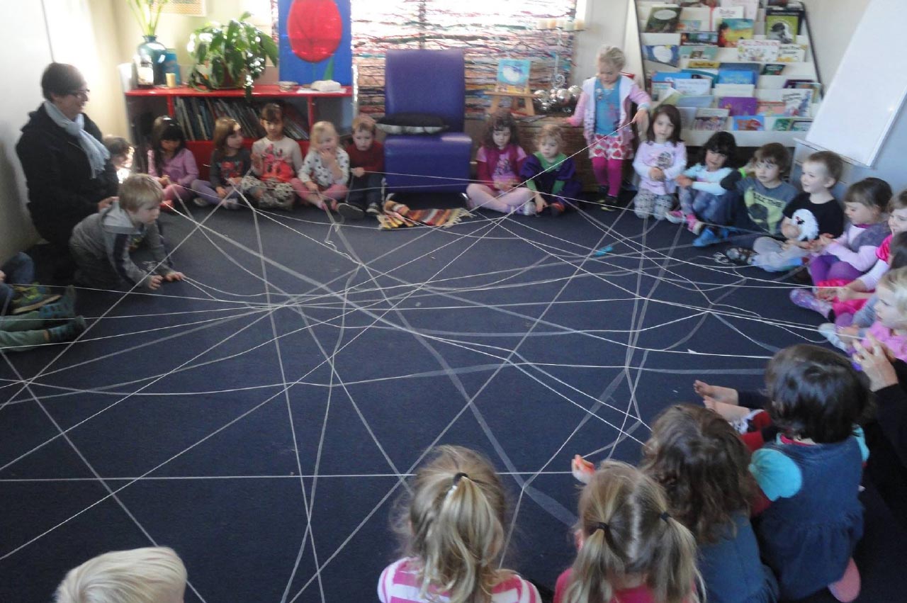 The children make a spiderweb together