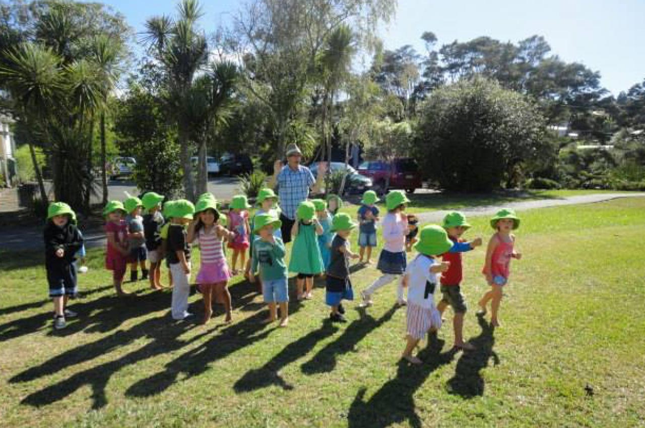 Children have a run around outside in the domain at Kaurilands Kindy