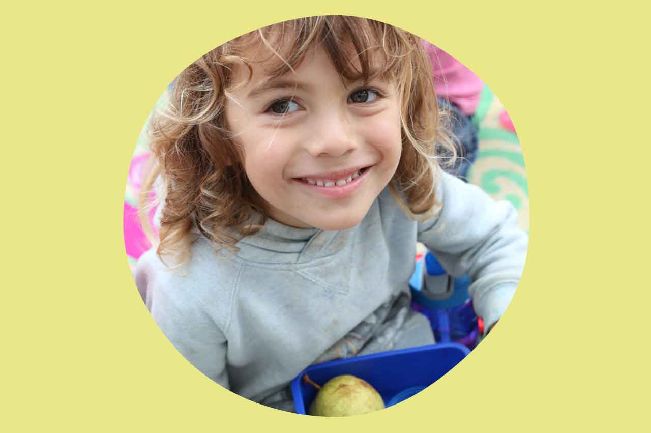 Big smile from a boy eating his lunch